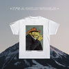White t-shirt with a graphic of a fisherman frog smoking a cigarette on a mountain background.