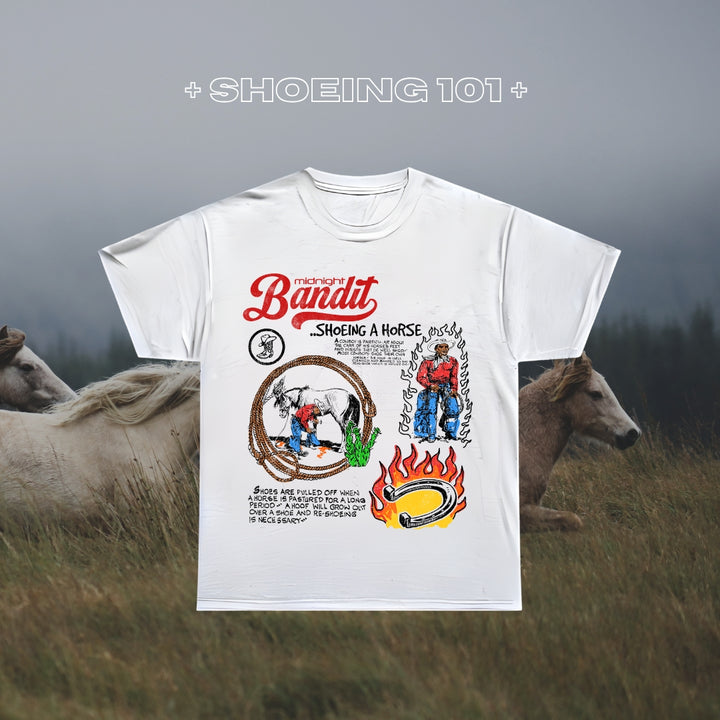 White t-shirt with 'The Bandit' graphic design featuring a horse and cowboy, set against a background of horses in a field.