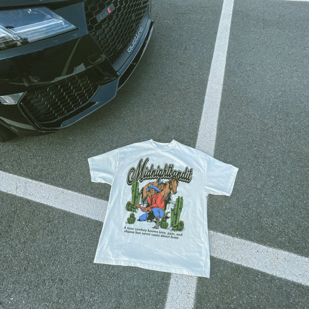 White t-shirt with graphic design on a black car hood